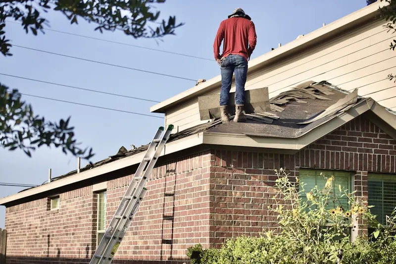 Professional roofer working on a residential roof in Sky Lake